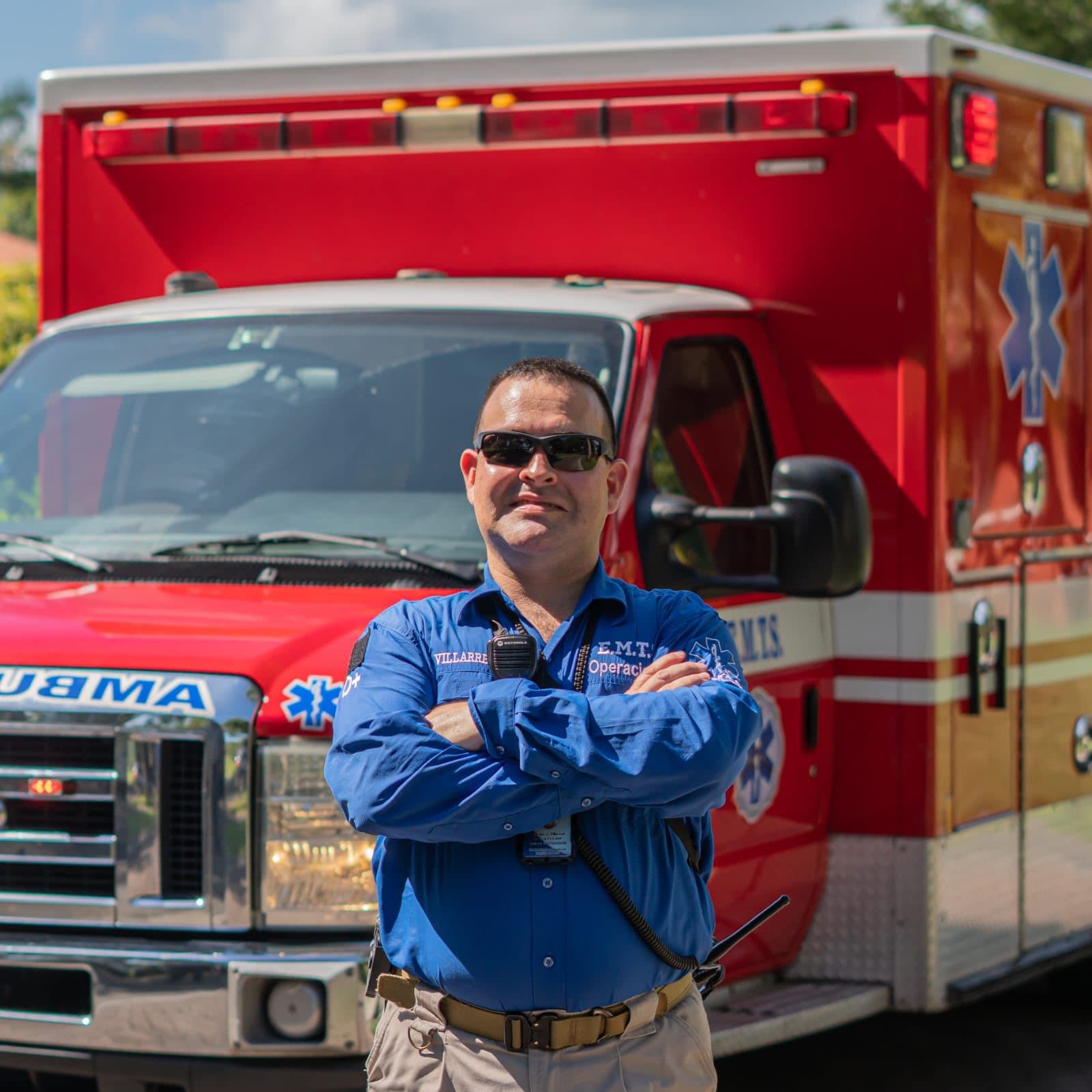 Arturo Villarreal in EMTS operations uniform beside an ambulance