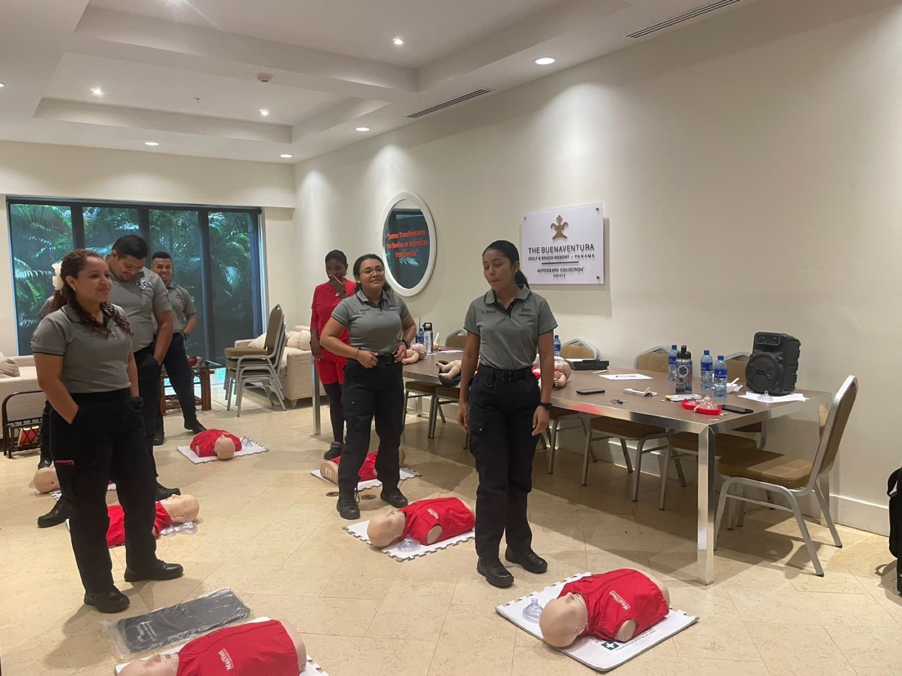 An EMTS CPR and AED class in progress with training manikins laid out