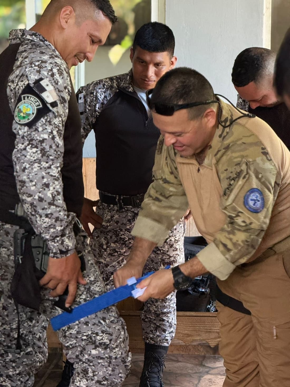 EMTS instructor demonstrating tourniquet application to Panamanian police officers